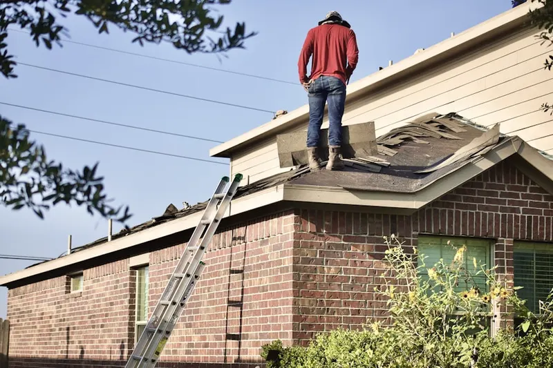 Professional roofer working on a residential roof in Progress Park
